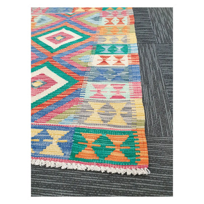 Angled detail of Afghan Chobi Kilim showing fringe, colourful side motifs, and handwoven flatweave pattern, 109 x 80 cm