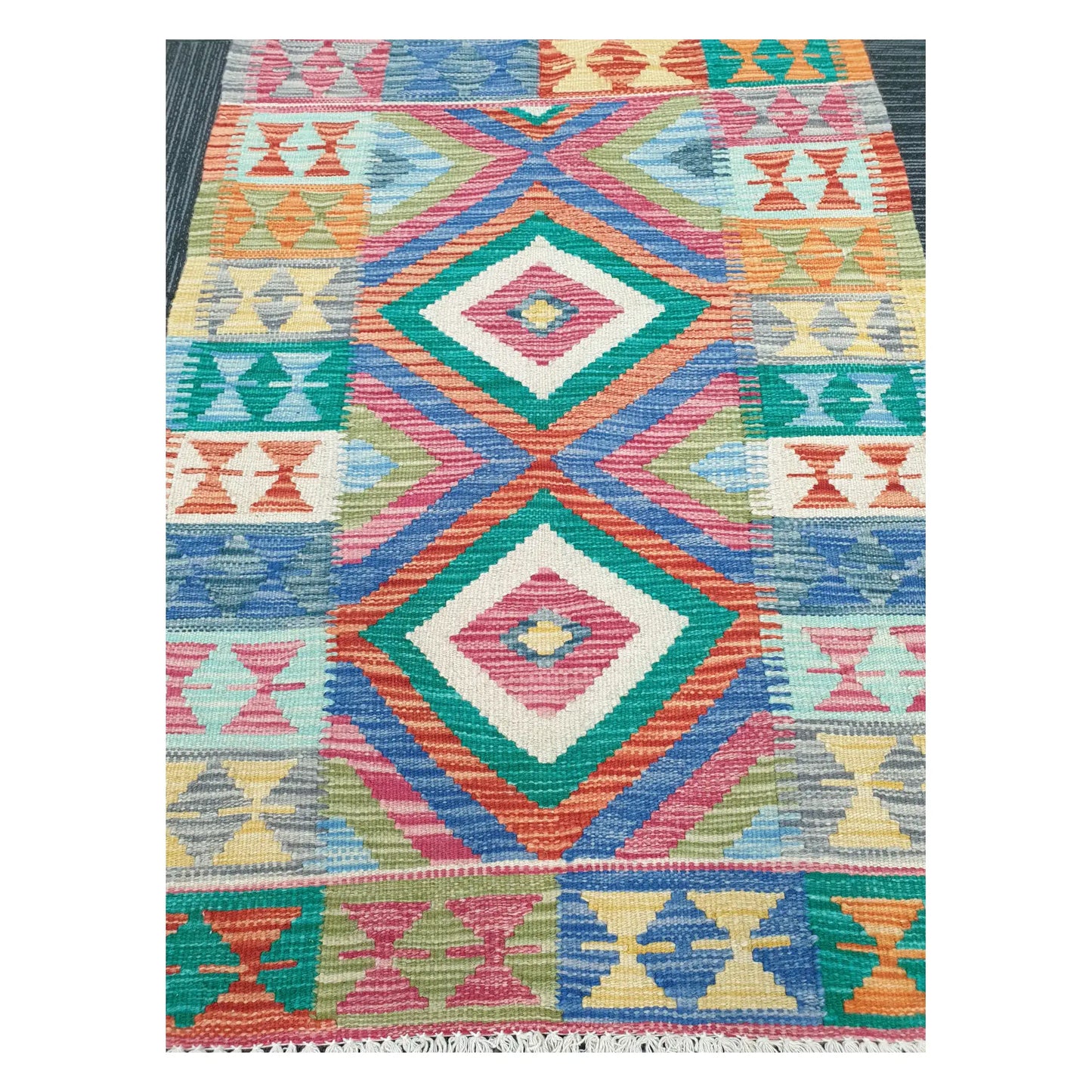 Close-up of Chobi Kilim rug with stacked diamond motifs in teal, coral, jade green, mustard, and powder blue, 109 x 80 cm