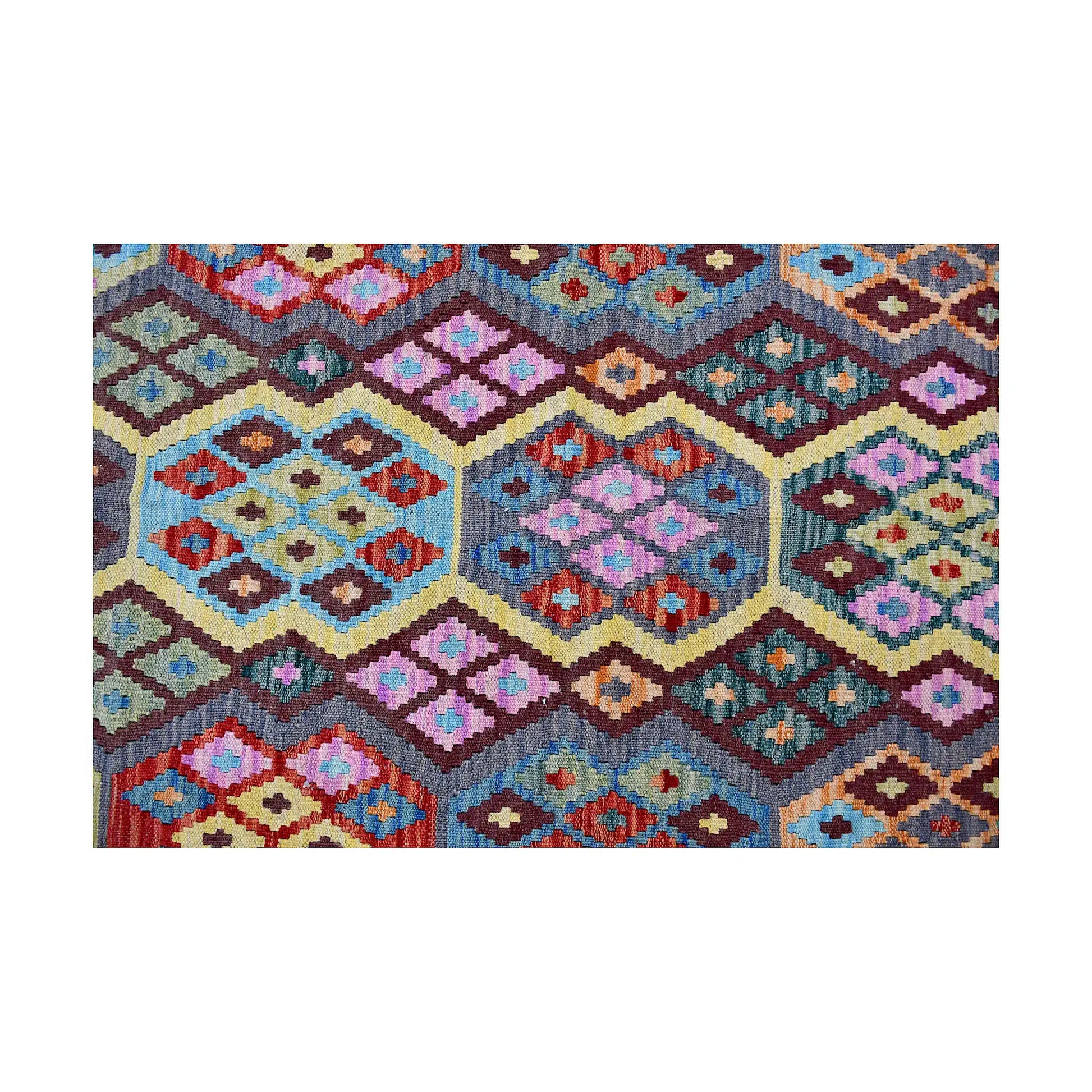 Close-up of colourful Chobi Kilim pattern with diamond motifs and burgundy accents