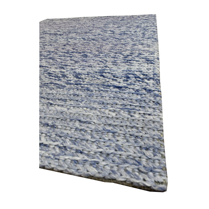 Angled view of Harlow blue hand-tufted wool rug showing its thick textured pile, tonal variation and finished edge