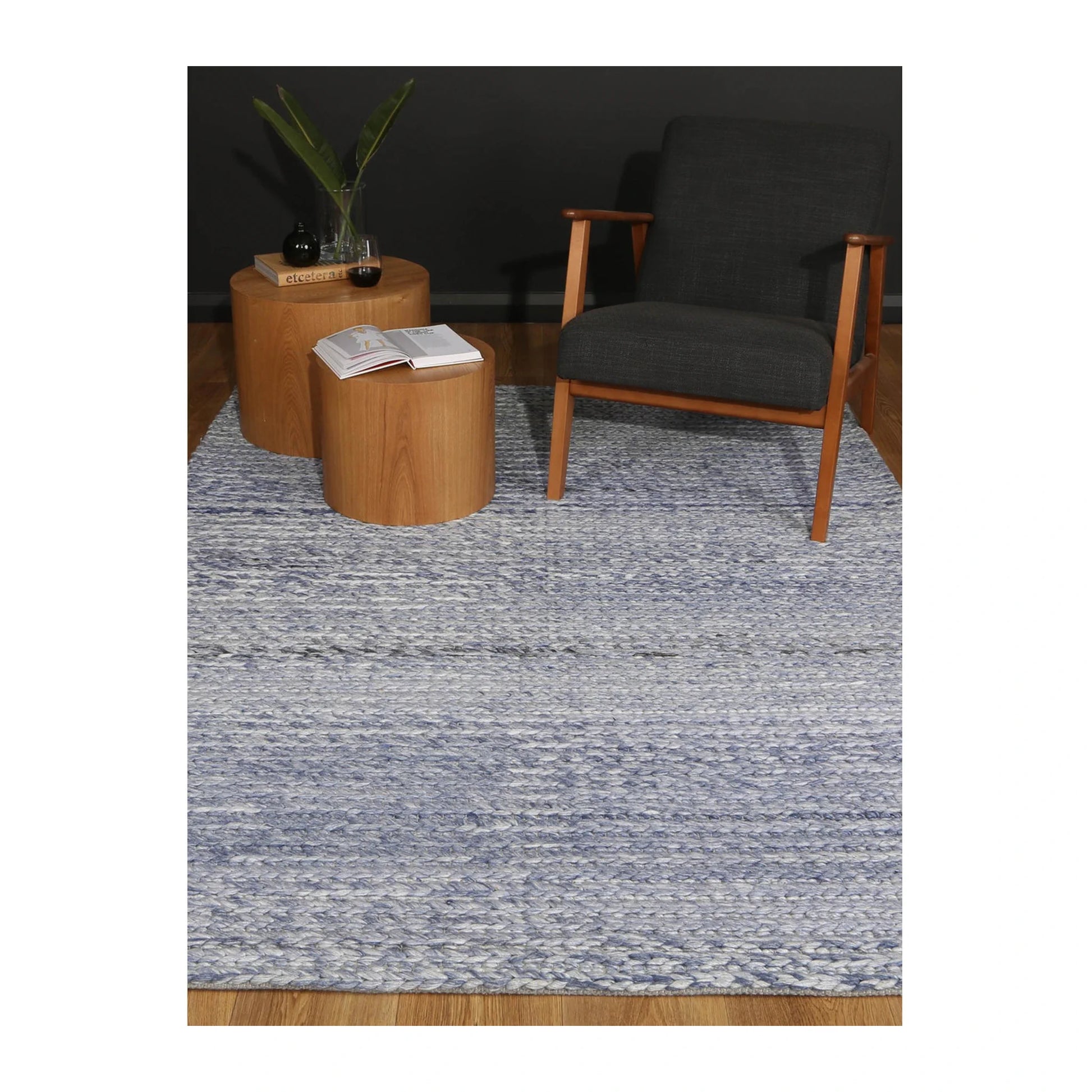 Lifestyle view of Harlow blue wool rug in a modern seating area, 230 x 160 cm