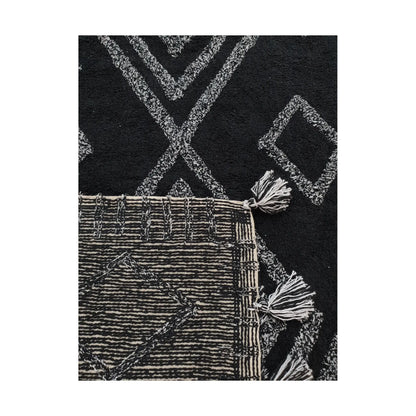 Fringe detail of Indian cotton black diamond rug showing tassels and woven texture