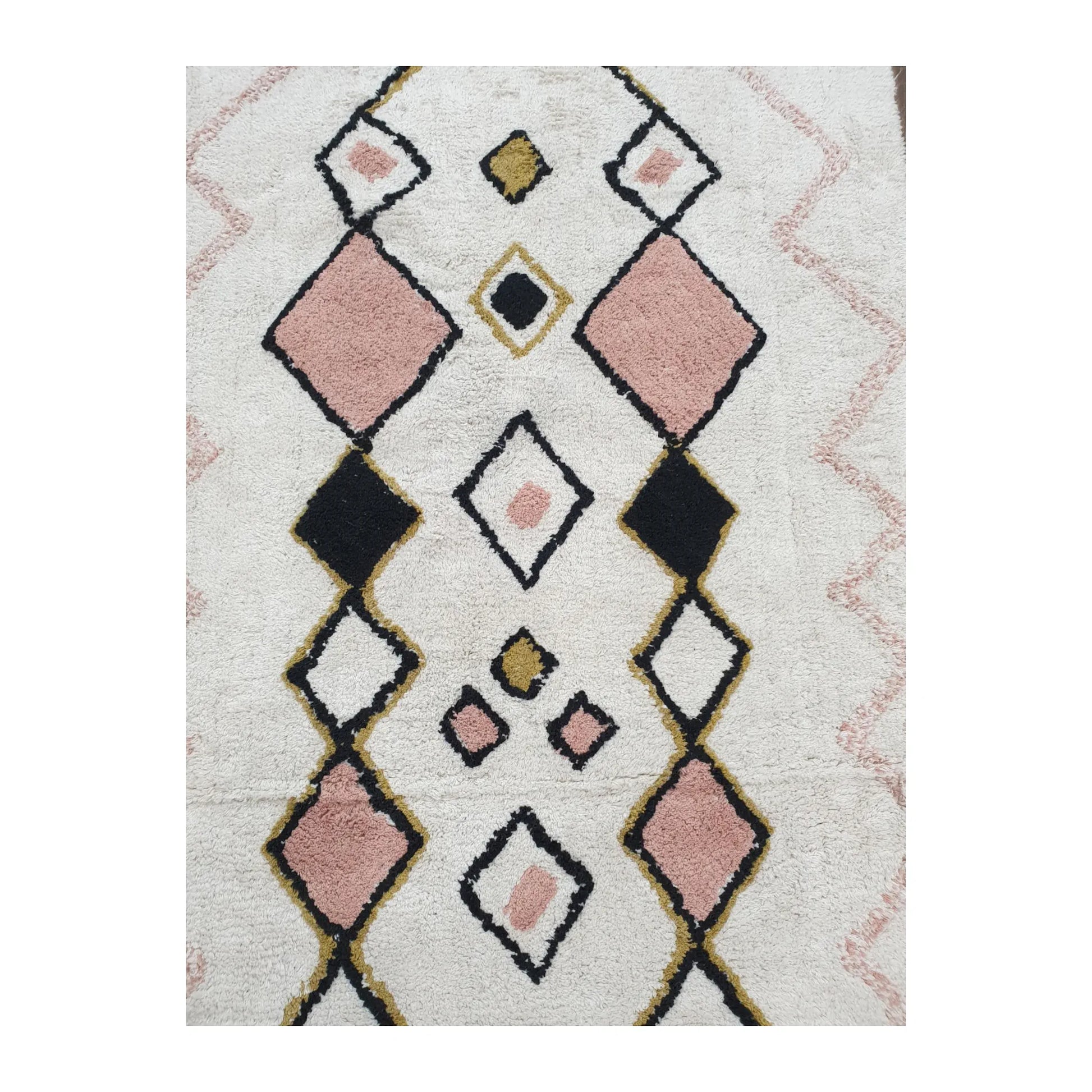 Pattern detail of Indian cotton white diamond rug showing pink, black and mustard diamond motifs