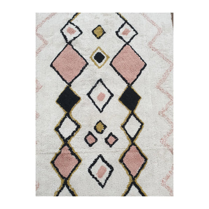 Pattern detail of Indian cotton white diamond rug showing pink, black and mustard diamond motifs