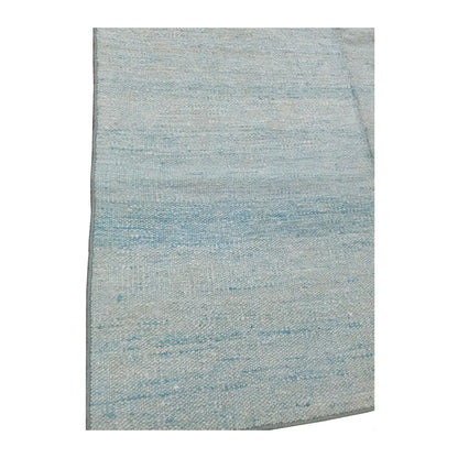 Close-up of Indian Dhurrie rug showing light blue and off-white tonal bands across the flatwoven surface