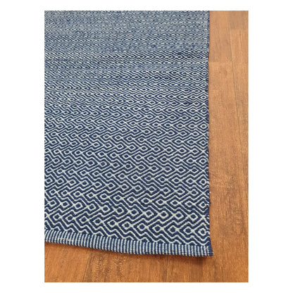 Angled edge detail of Indian Dhurrie showing blue woven geometric pattern and flatweave texture, 230 x 160 cm