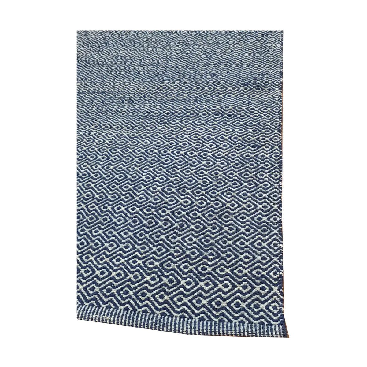 Angled edge detail of Indian Dhurrie showing blue woven geometric pattern and flatweave texture, 230 x 160 cm