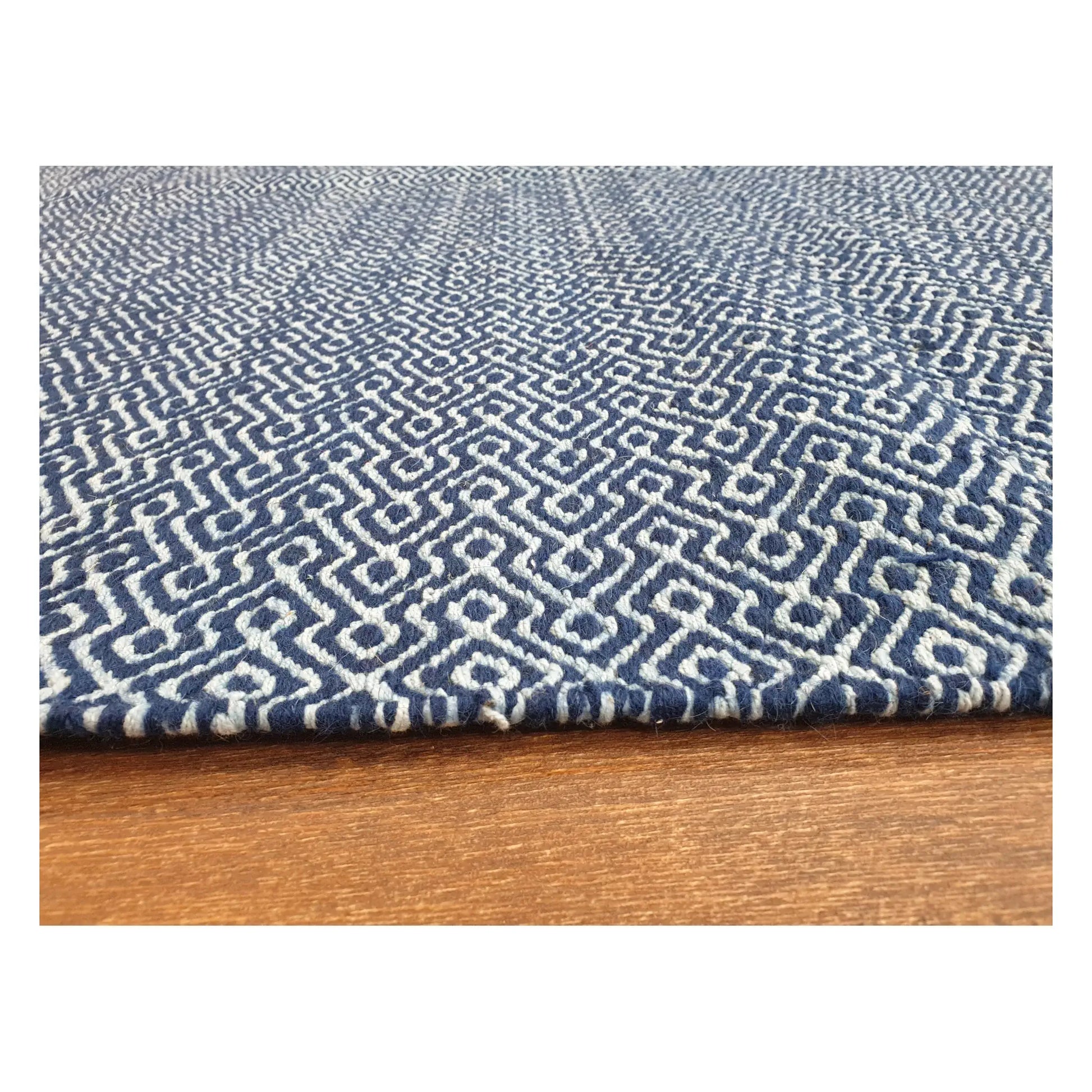 Low-angle close-up of Indian Dhurrie rug with blue geometric weave and flatweave texture, 230 x 160 cm