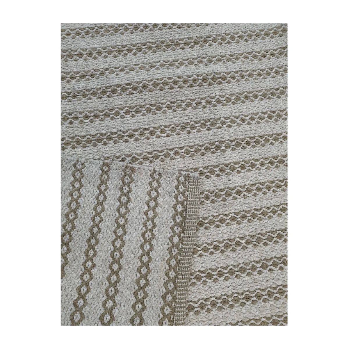 Close-up of folded Indian Dhurrie rug showing limestone woven pattern detail, 290 x 200 cm 