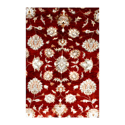 Close-up of floral rosettes, small blossoms and leaves across the Indian Ziegler rug’s red field