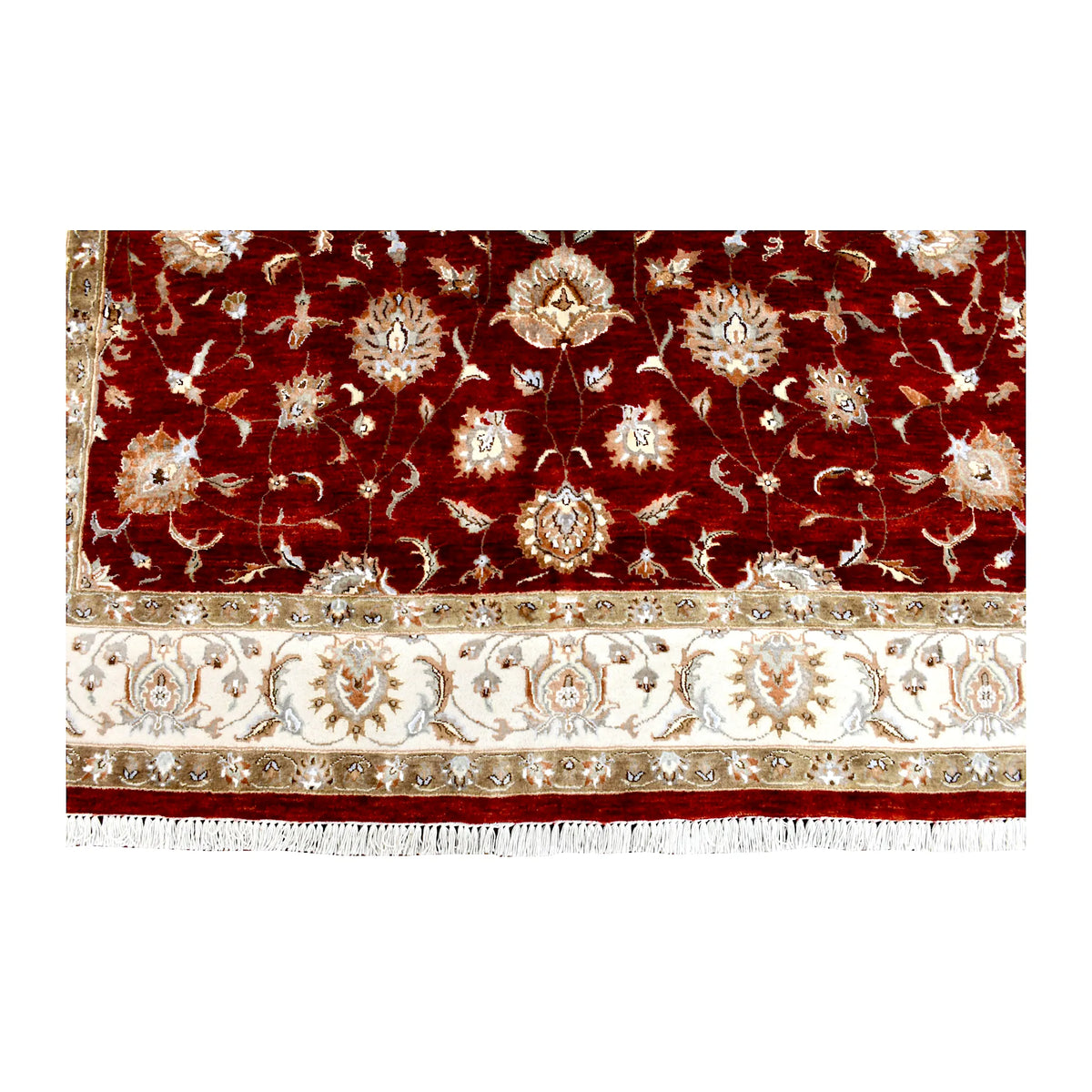 Fringe-end detail of Indian Ziegler rug showing pale flowers on the red field above the ivory floral border