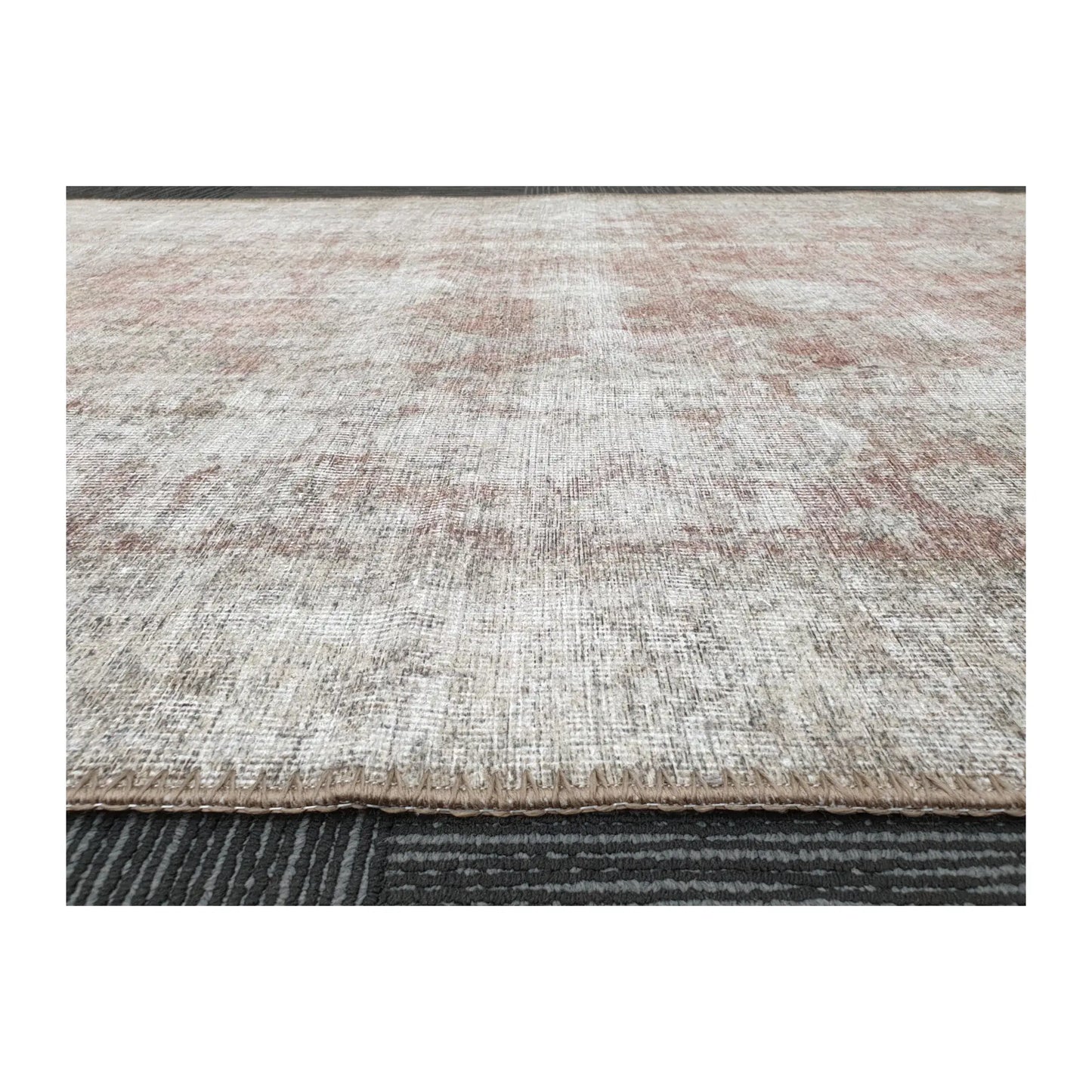 Low-angle close-up of ivory blush cotton rug edge and woven surface texture