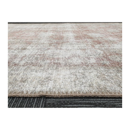 Low-angle close-up of ivory blush cotton rug edge and woven surface texture