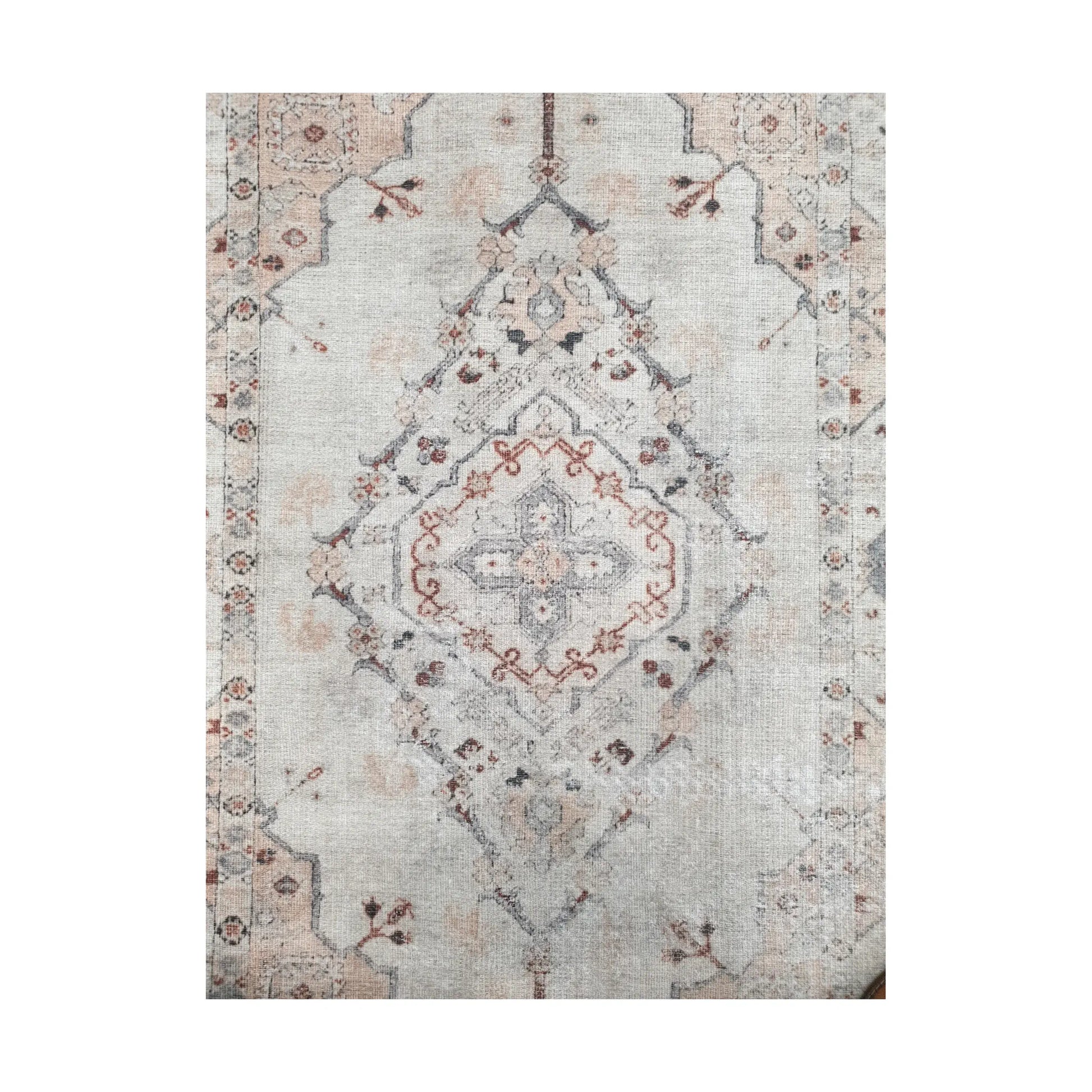 Close-up of ivory blush cotton rug central medallion and floral pattern detail