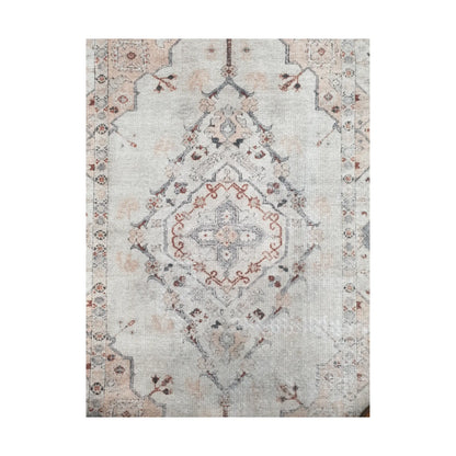 Close-up of ivory blush cotton rug central medallion and floral pattern detail