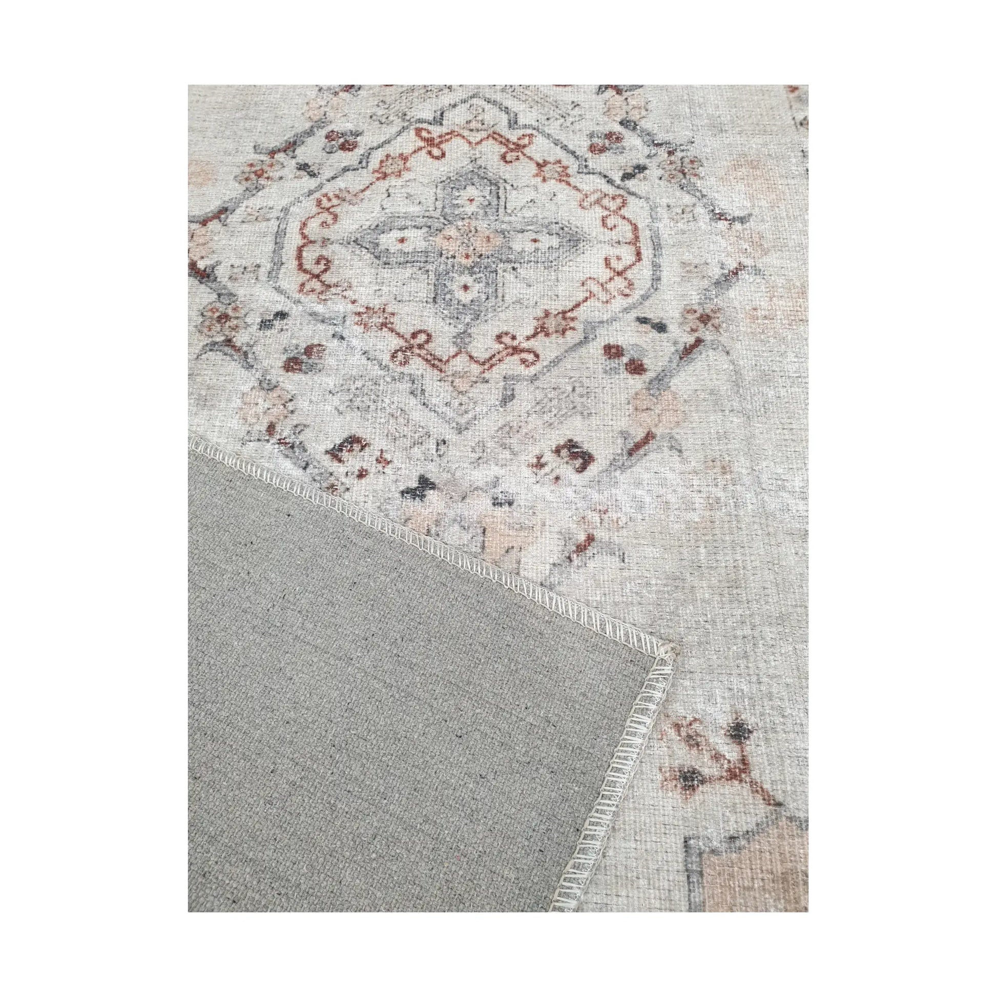 Close-up of ivory blush cotton rug corner with back and edge detail