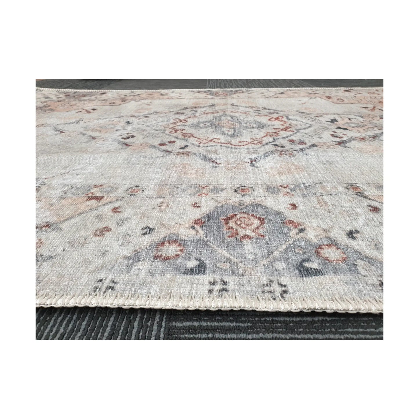 Low-angle close-up of ivory blush cotton rug edge and woven surface texture