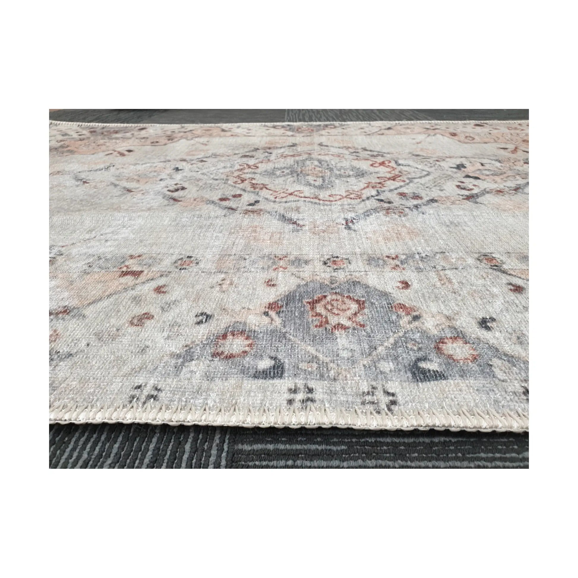 Low-angle close-up of ivory blush cotton rug edge and woven surface texture