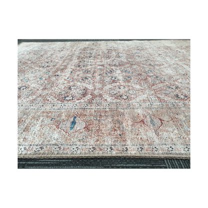 Low-angle close-up of ivory blush teal cotton rug edge and woven surface texture