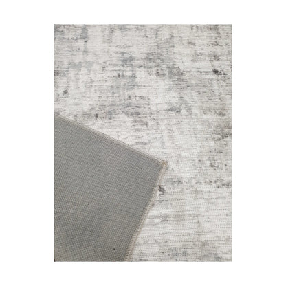 Close-up of ivory grey cotton rug corner with back and edge detail