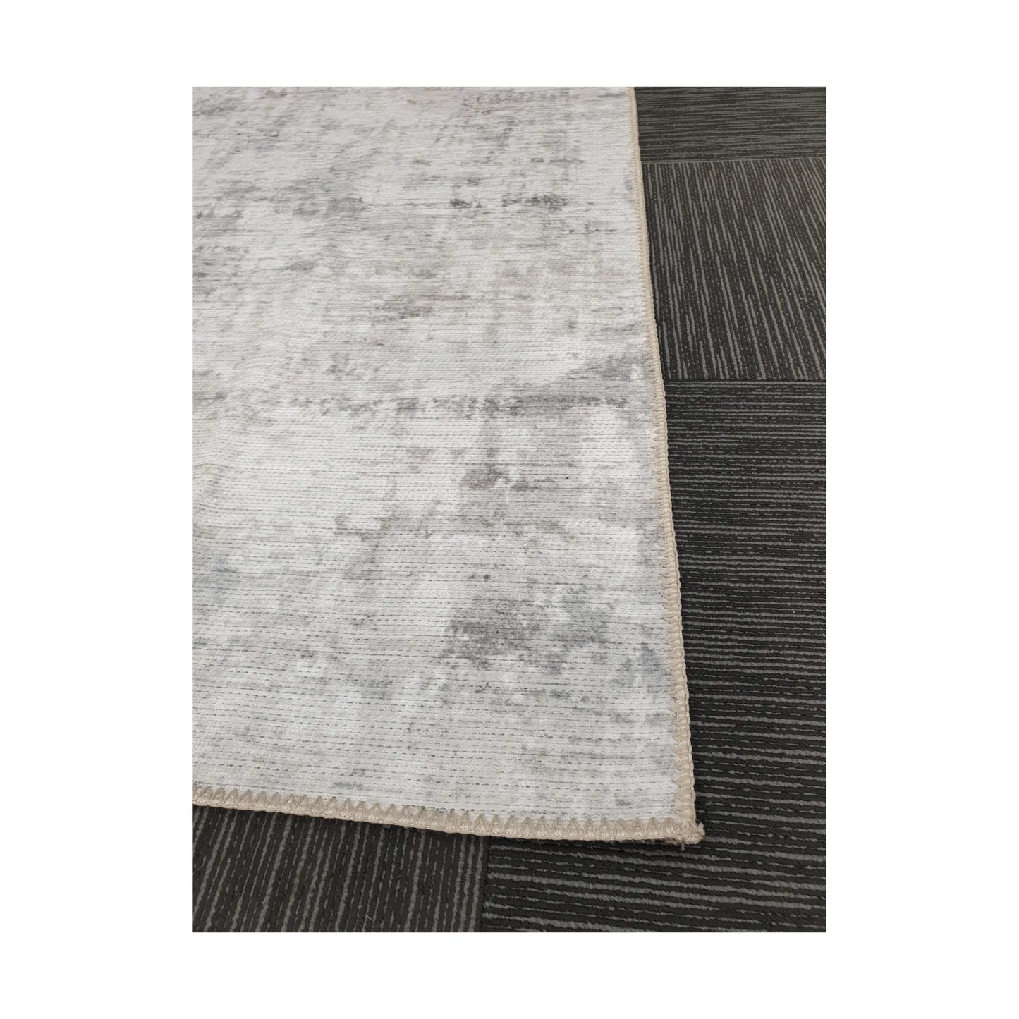 Close-up of ivory grey cotton rug corner with edge and surface detail