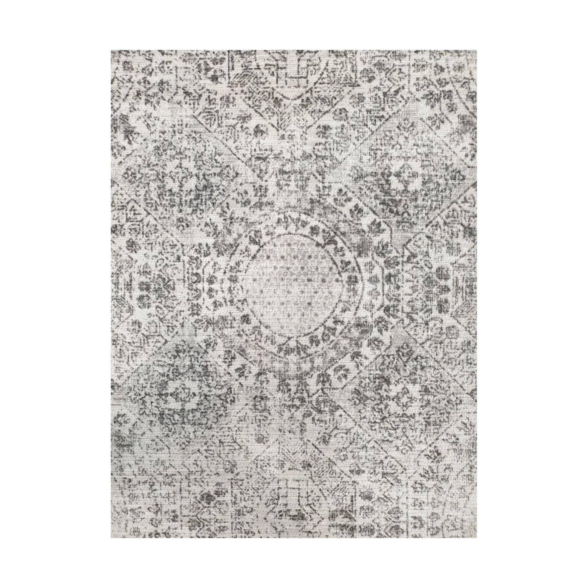 Close-up of ivory grey cotton rug central medallion and ornamental floral pattern