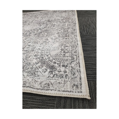 Close-up of ivory grey cotton rug corner with floral border detail