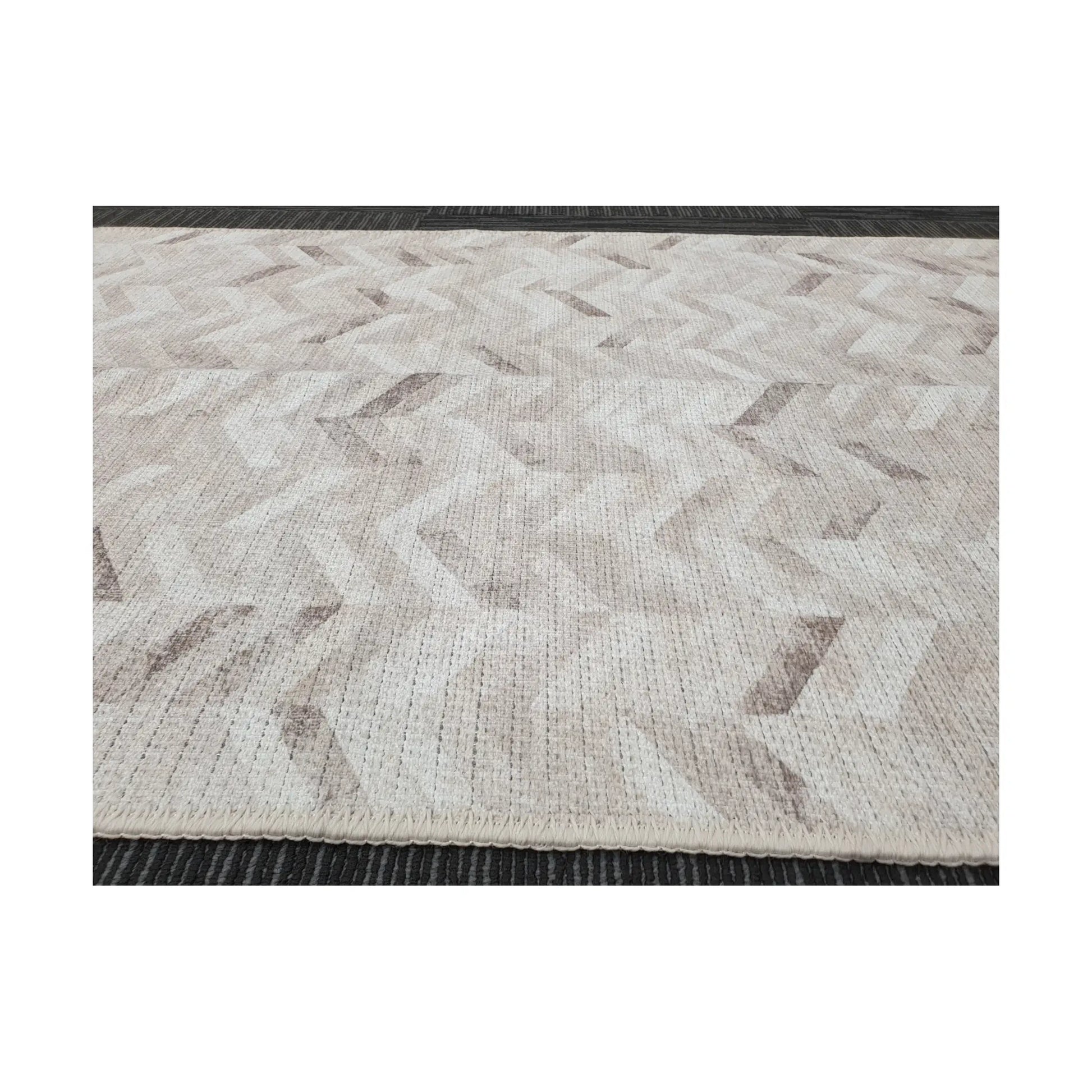 Low-angle close-up of ivory grey herringbone cotton runner rug edge and woven texture