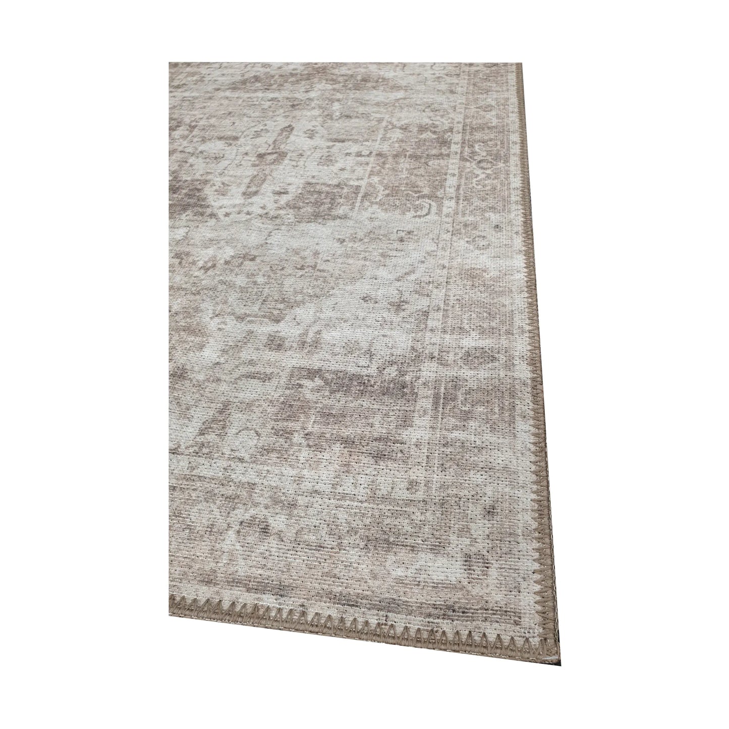 Close-up of ivory grey cotton runner rug corner with faded ornamental border detail