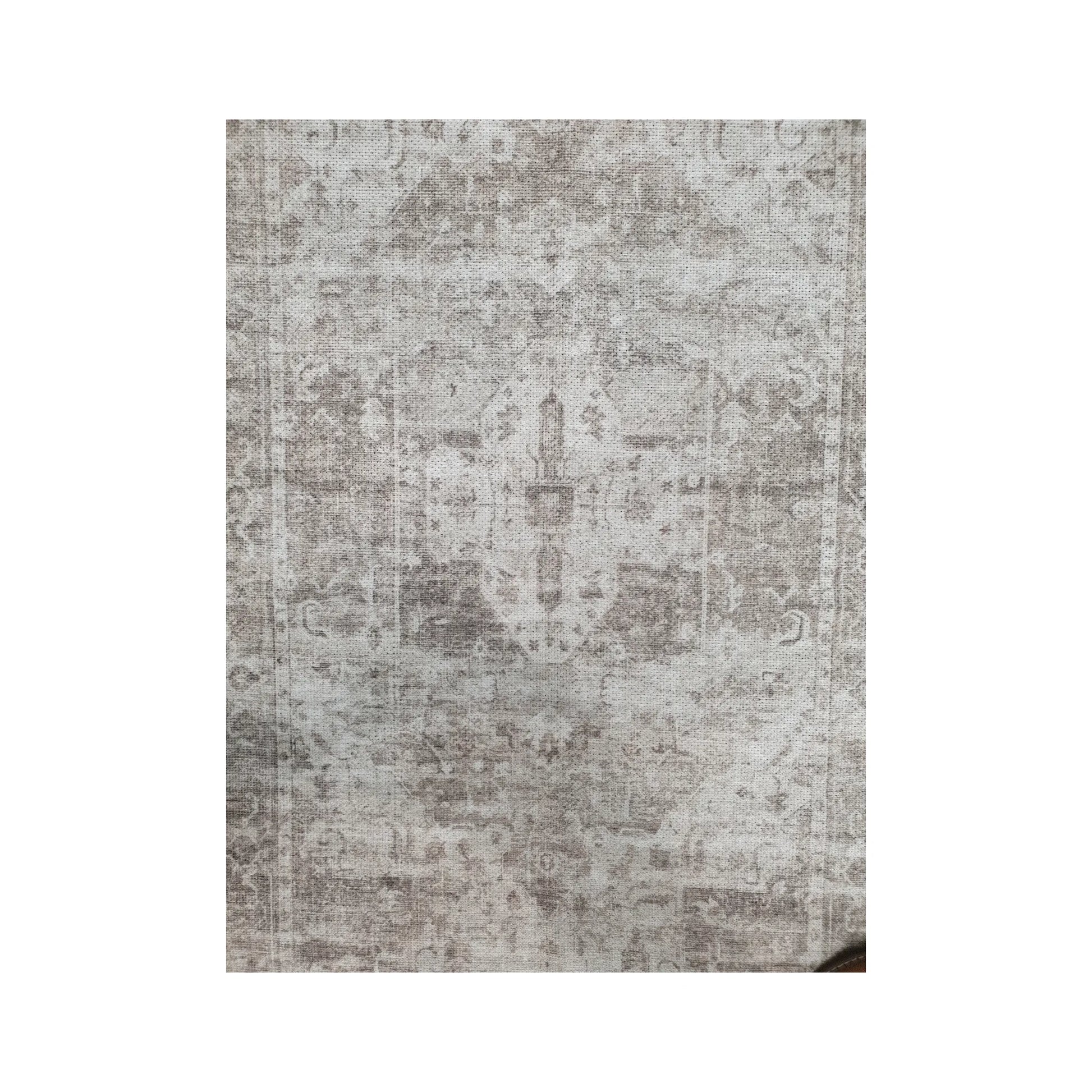 Close-up of ivory grey cotton runner rug faded surface pattern and central detail