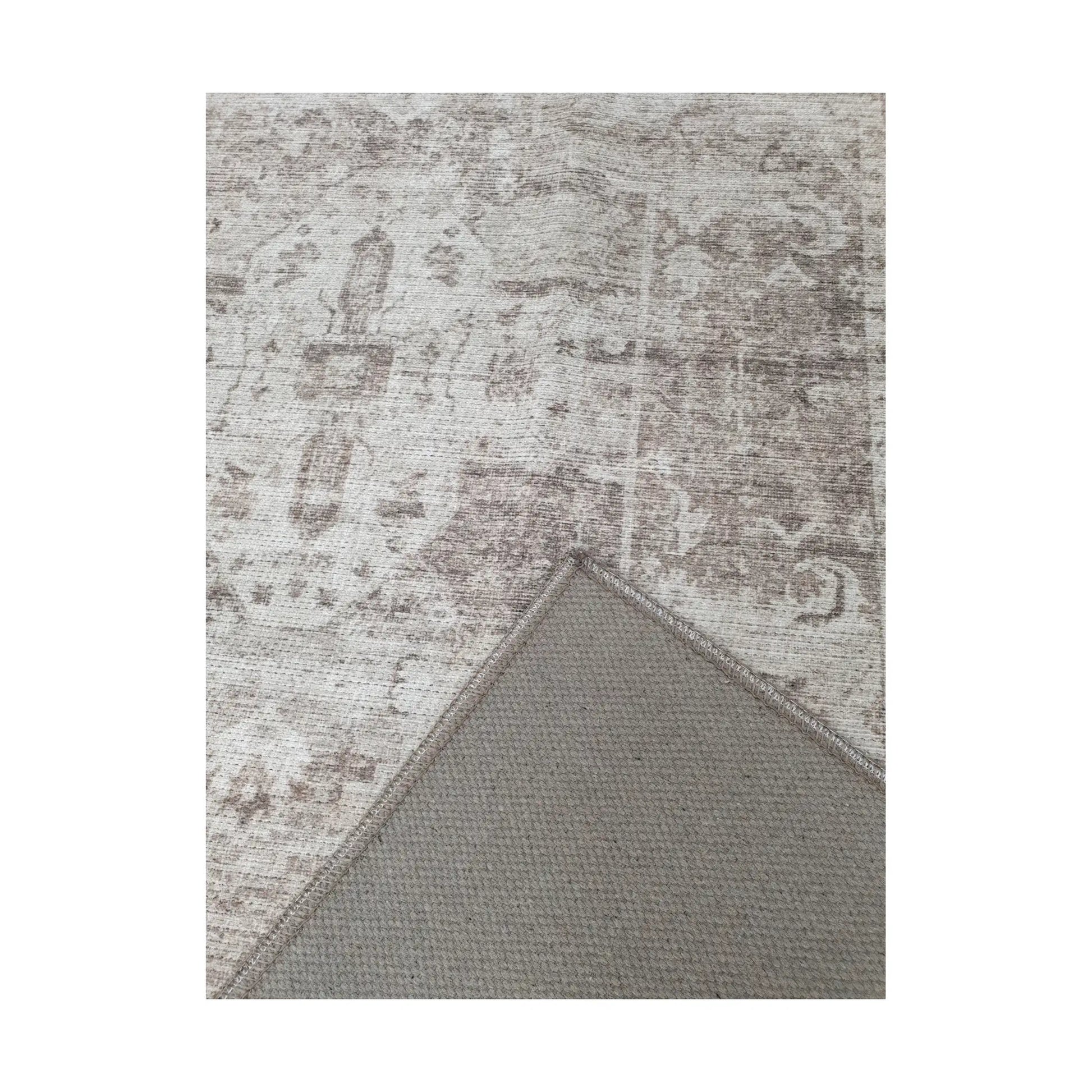 Close-up of ivory grey cotton rug corner with back and edge detail