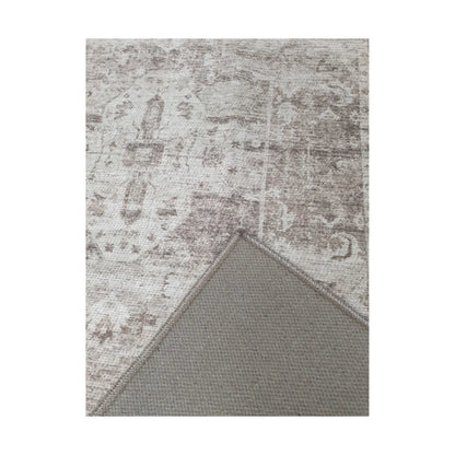 Close-up of ivory grey cotton rug corner with back and edge detail