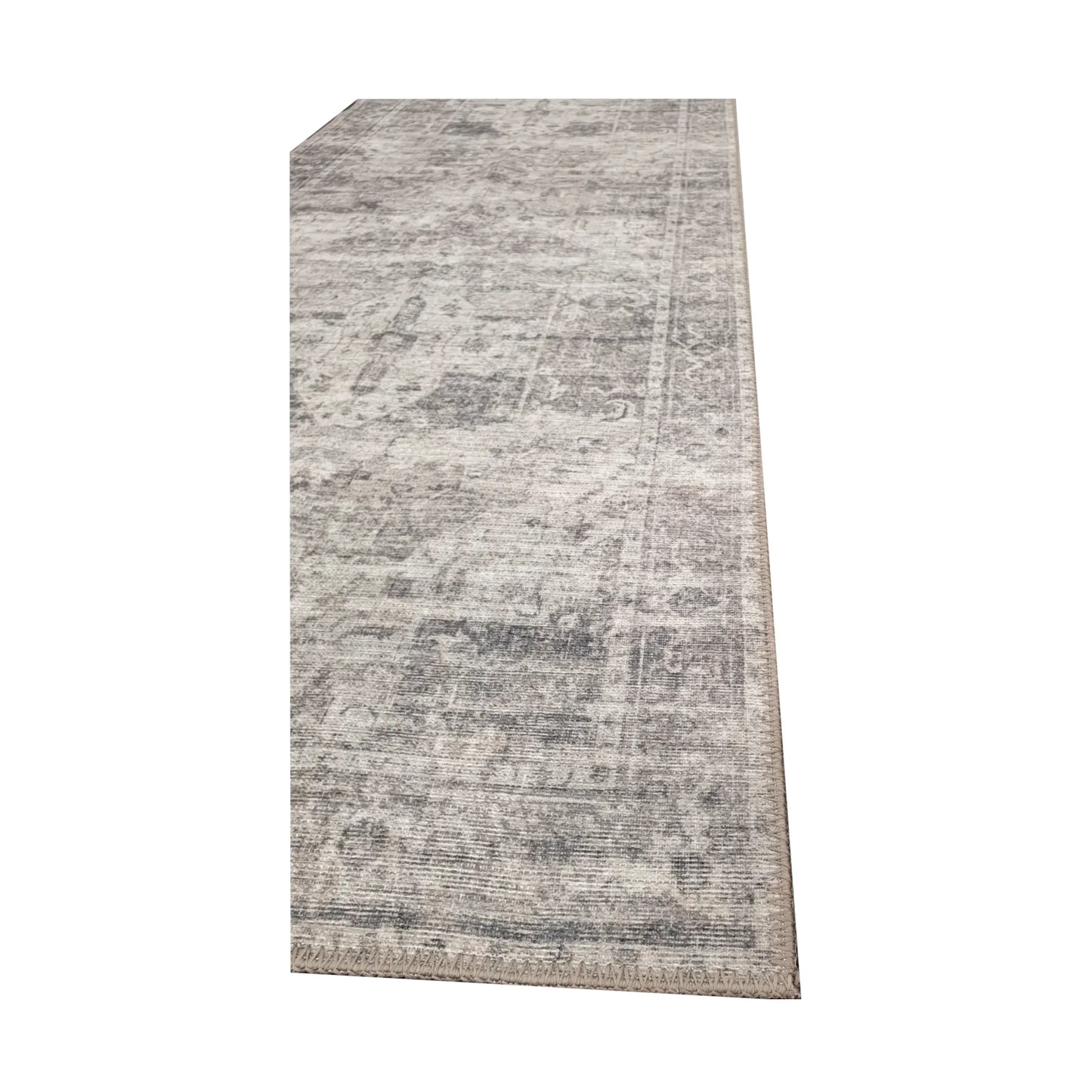 Close-up of ivory grey cotton runner rug corner with subtle ornamental edge detail