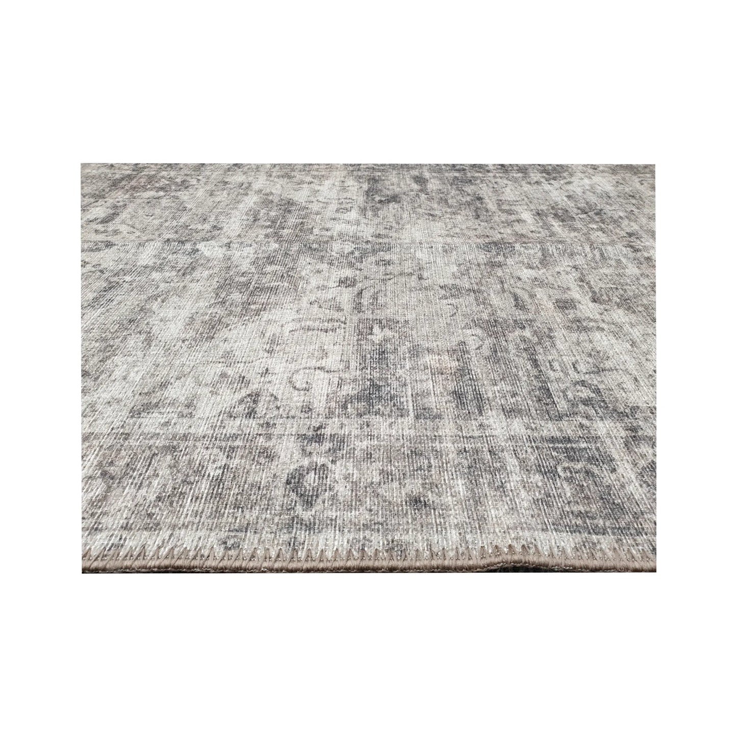 Low-angle close-up of ivory grey cotton runner rug edge and woven surface texture