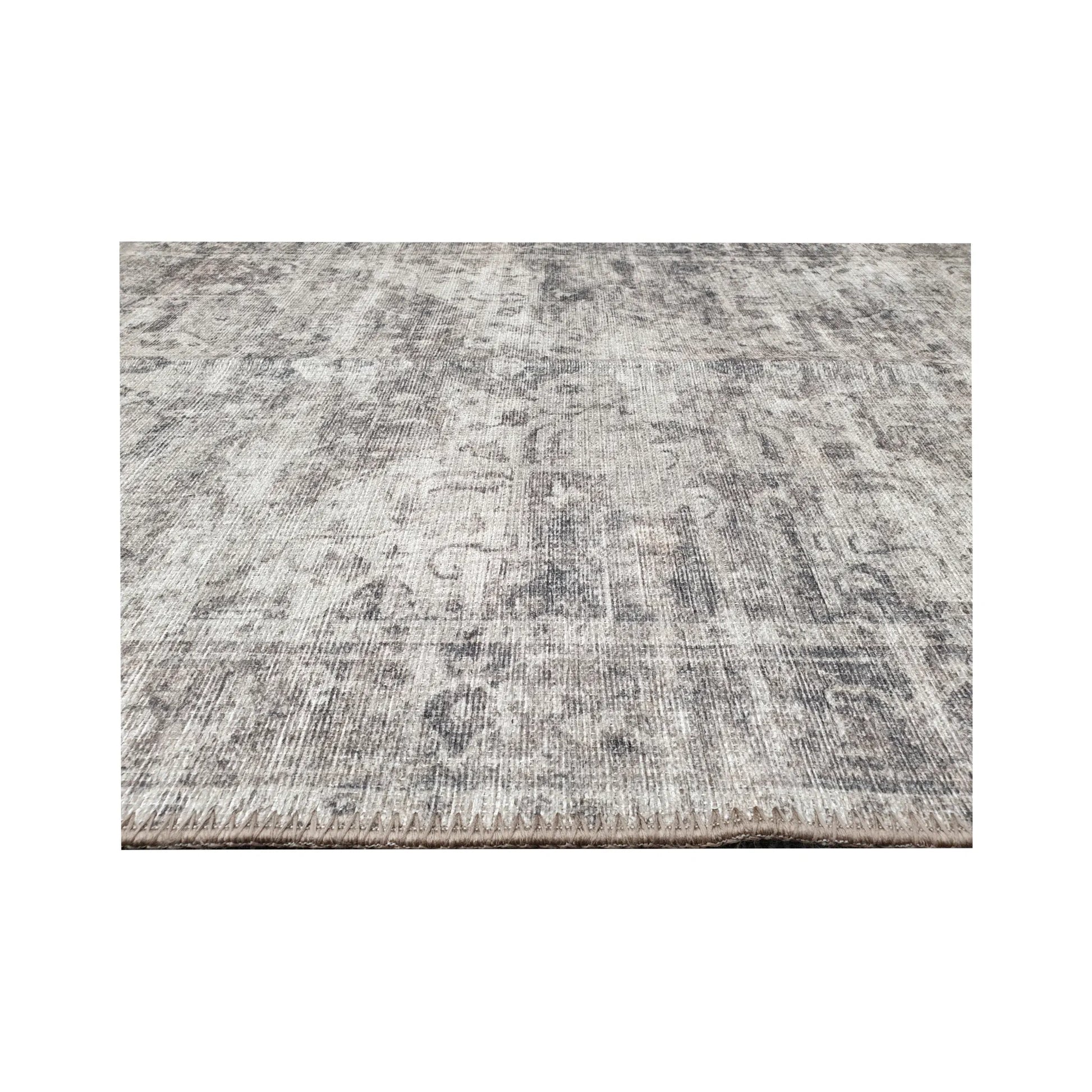 Low-angle close-up of ivory grey cotton runner rug edge and woven surface texture