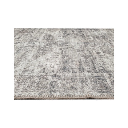 Low-angle close-up of ivory grey cotton runner rug edge and woven surface texture