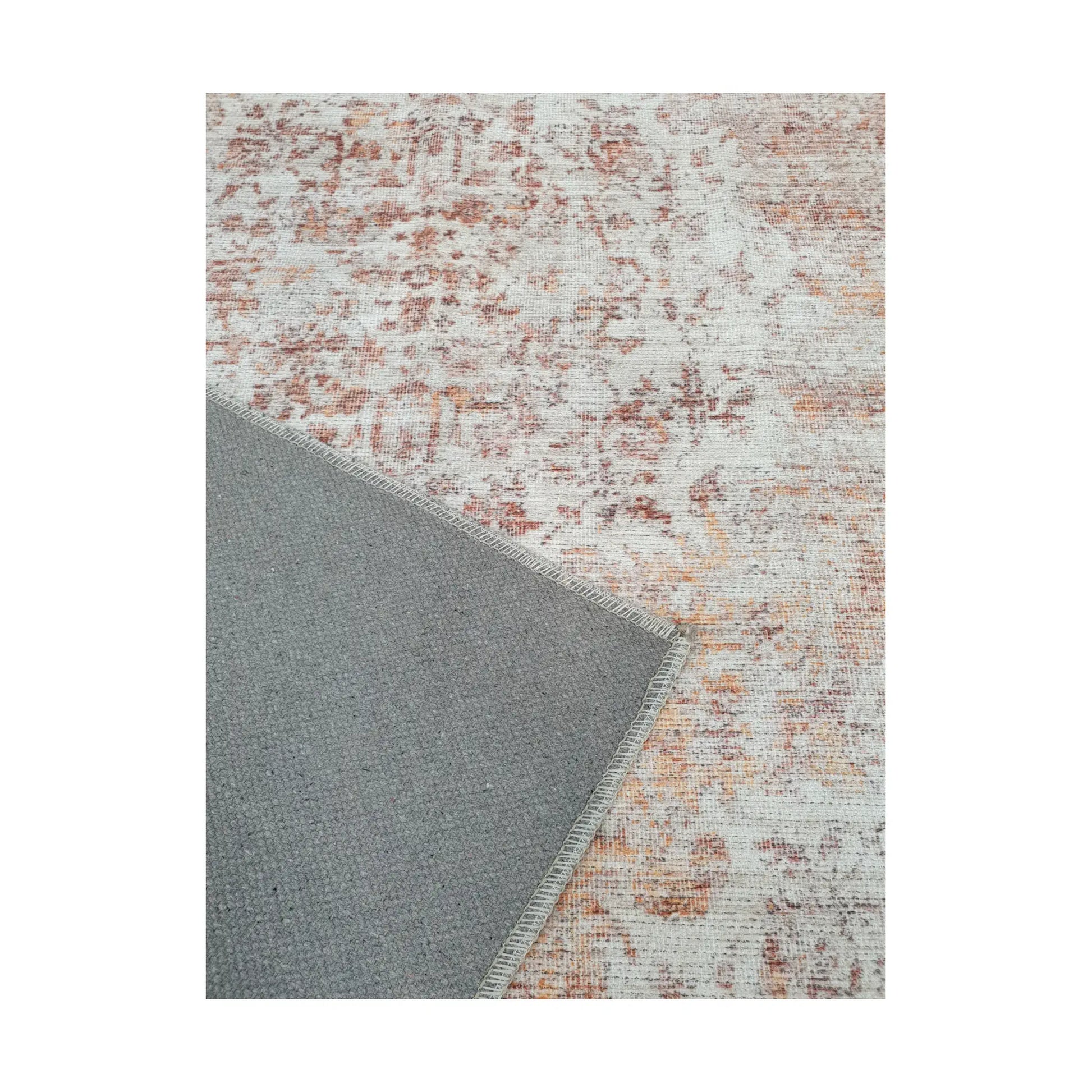 Close-up of ivory rust cotton rug corner with back and edge detail