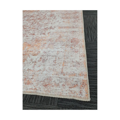 Close-up of ivory rust cotton rug corner with abstract surface and edge detail
