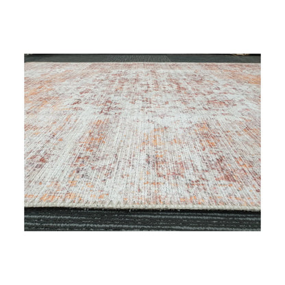 Low-angle close-up of ivory rust cotton rug edge and woven surface texture