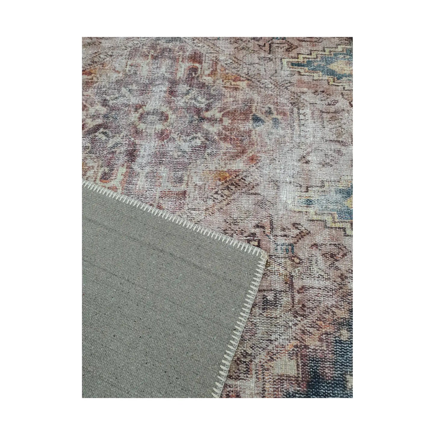 Close-up of ivory teal rust cotton rug corner with back and edge detail