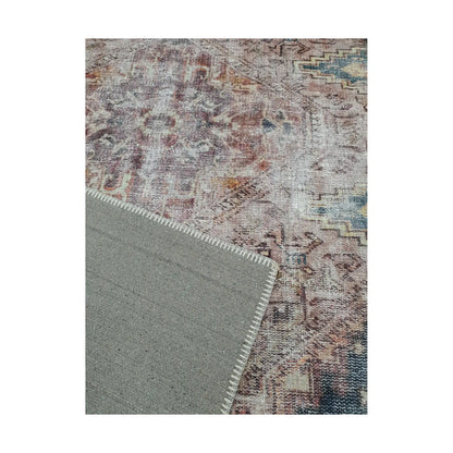 Close-up of ivory teal rust cotton rug corner with back and edge detail