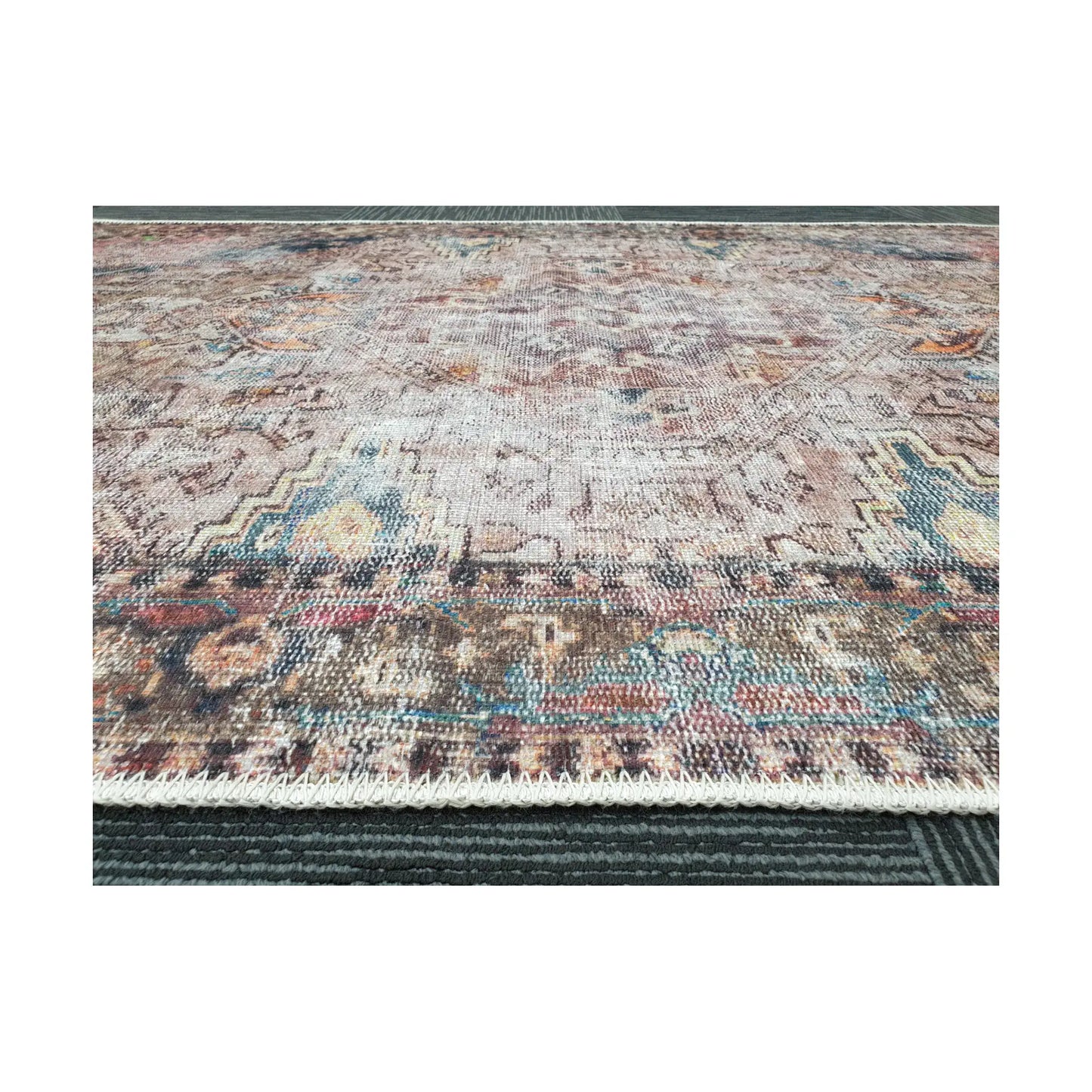 Low-angle close-up of ivory teal rust cotton rug edge and woven surface texture
