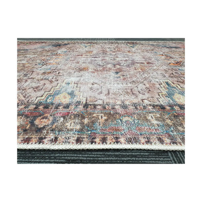 Low-angle close-up of ivory teal rust cotton rug edge and woven surface texture