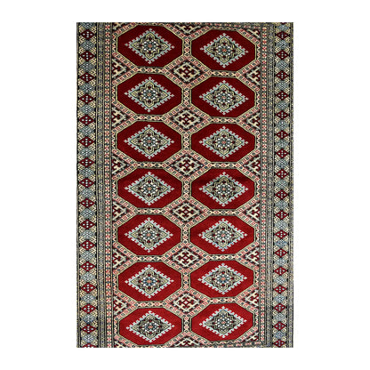 Full field detail of Jaldar rug showing repeating angular guls within deep red octagonal compartments