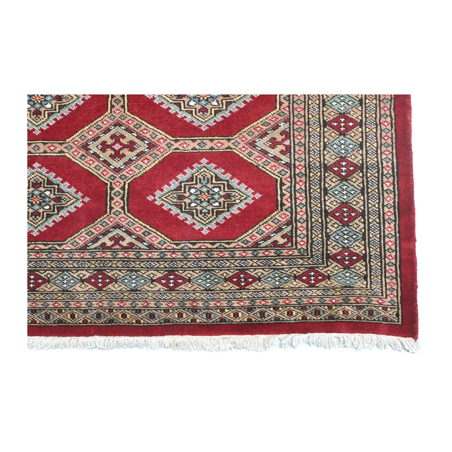 Close-up of Jaldar rug showing the patterned end border and visible fringe