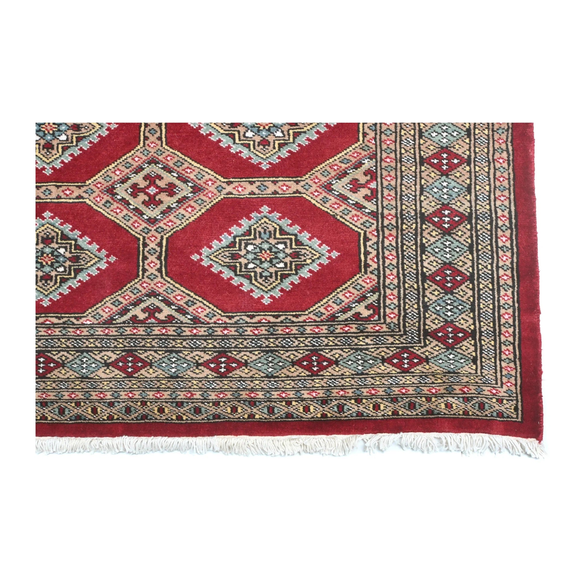 Close-up of Jaldar rug showing the patterned end border and visible fringe