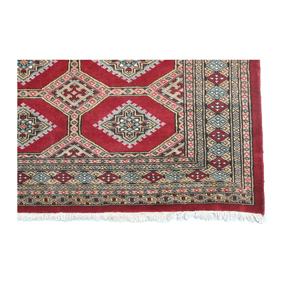 Close-up of Jaldar rug showing the patterned end border and visible fringe