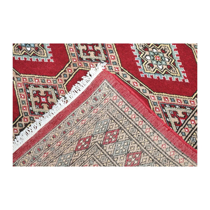 Folded-corner detail of Jaldar rug showing the patterned field, reverse weave and visible fringe