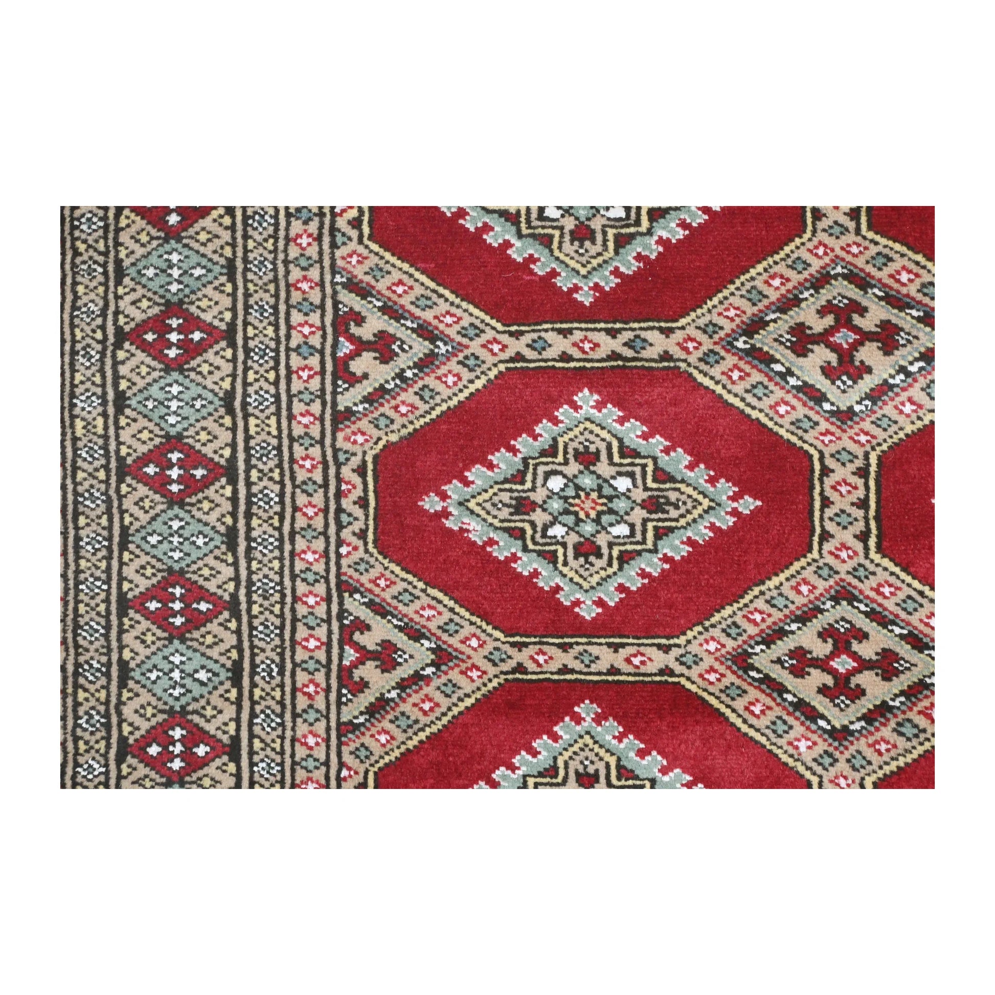 Close-up of Jaldar rug showing an angular gul within a red octagonal panel and the layered side border