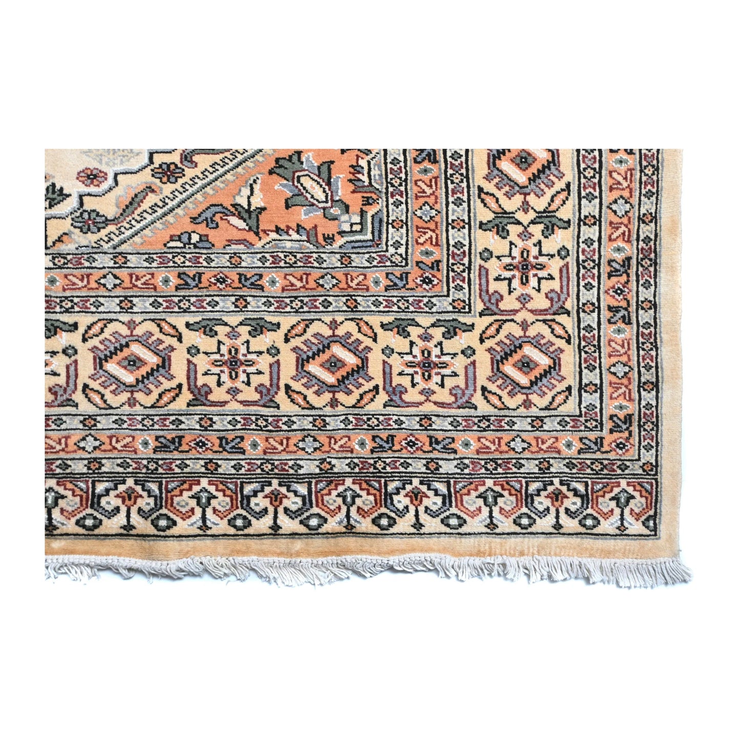 Close-up of Jaldar rug showing the patterned end border and visible fringe